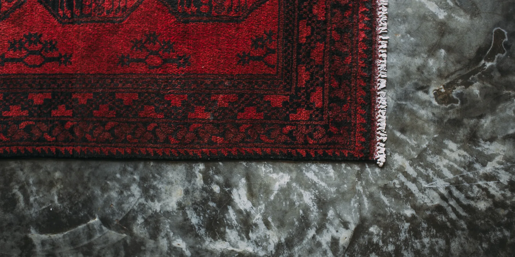 A roll of broadloom carpet being unrolled across a room