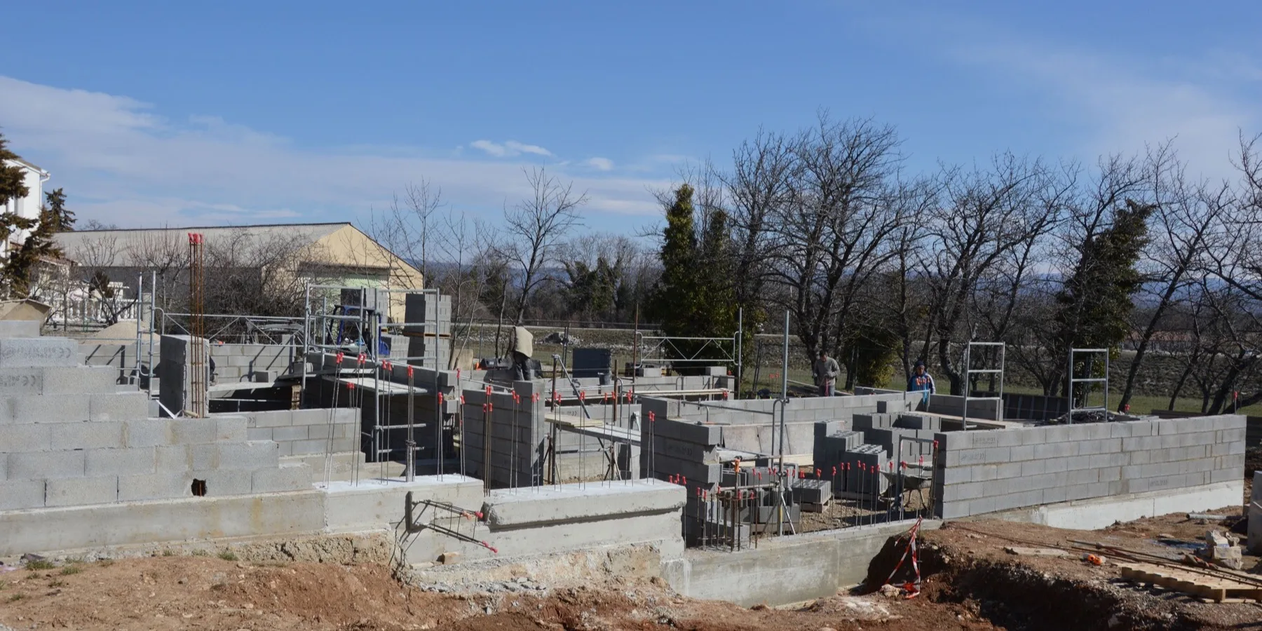A concrete block wall going up in running bond