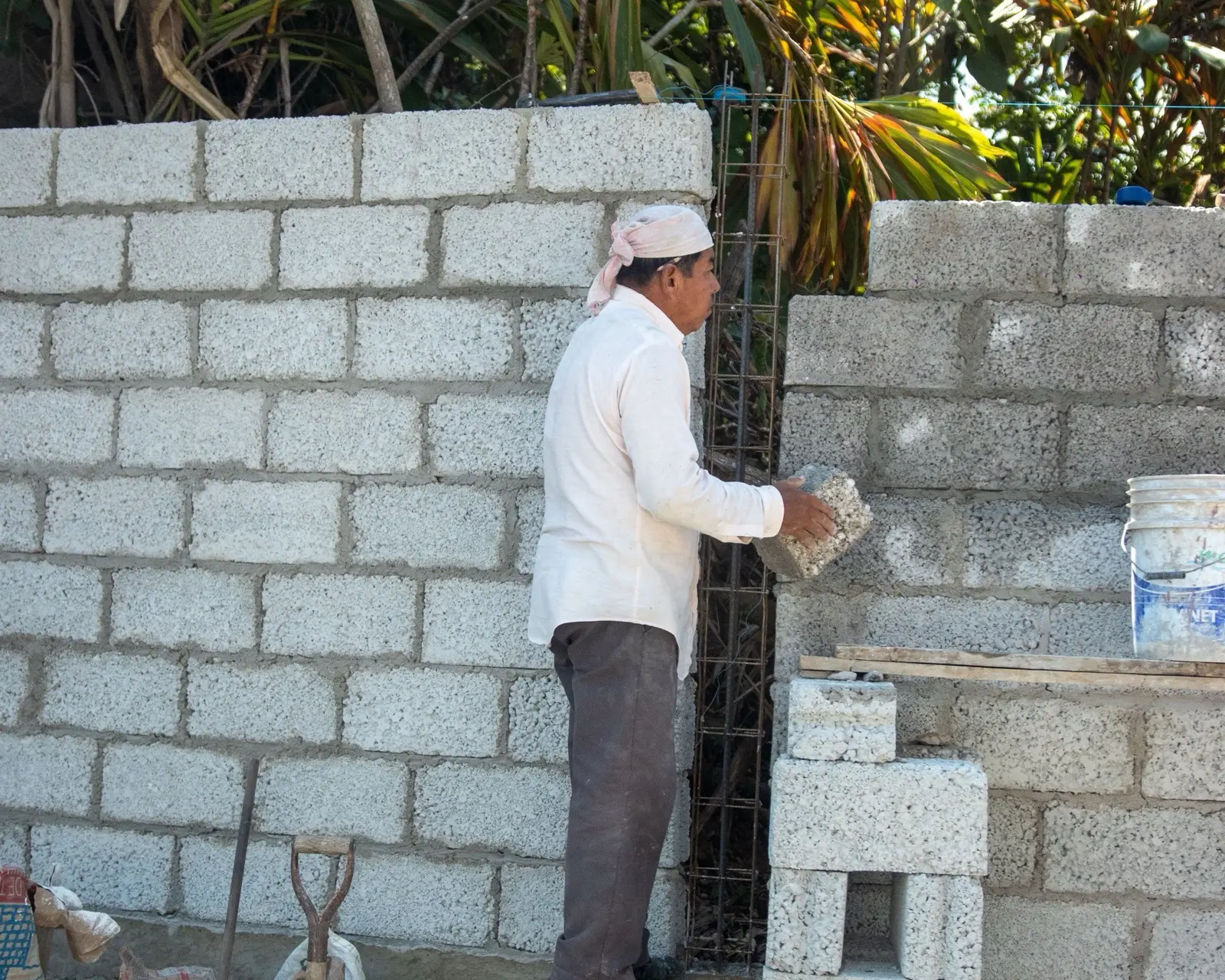 Concrete blocks stacked beside a mortar board and trowel