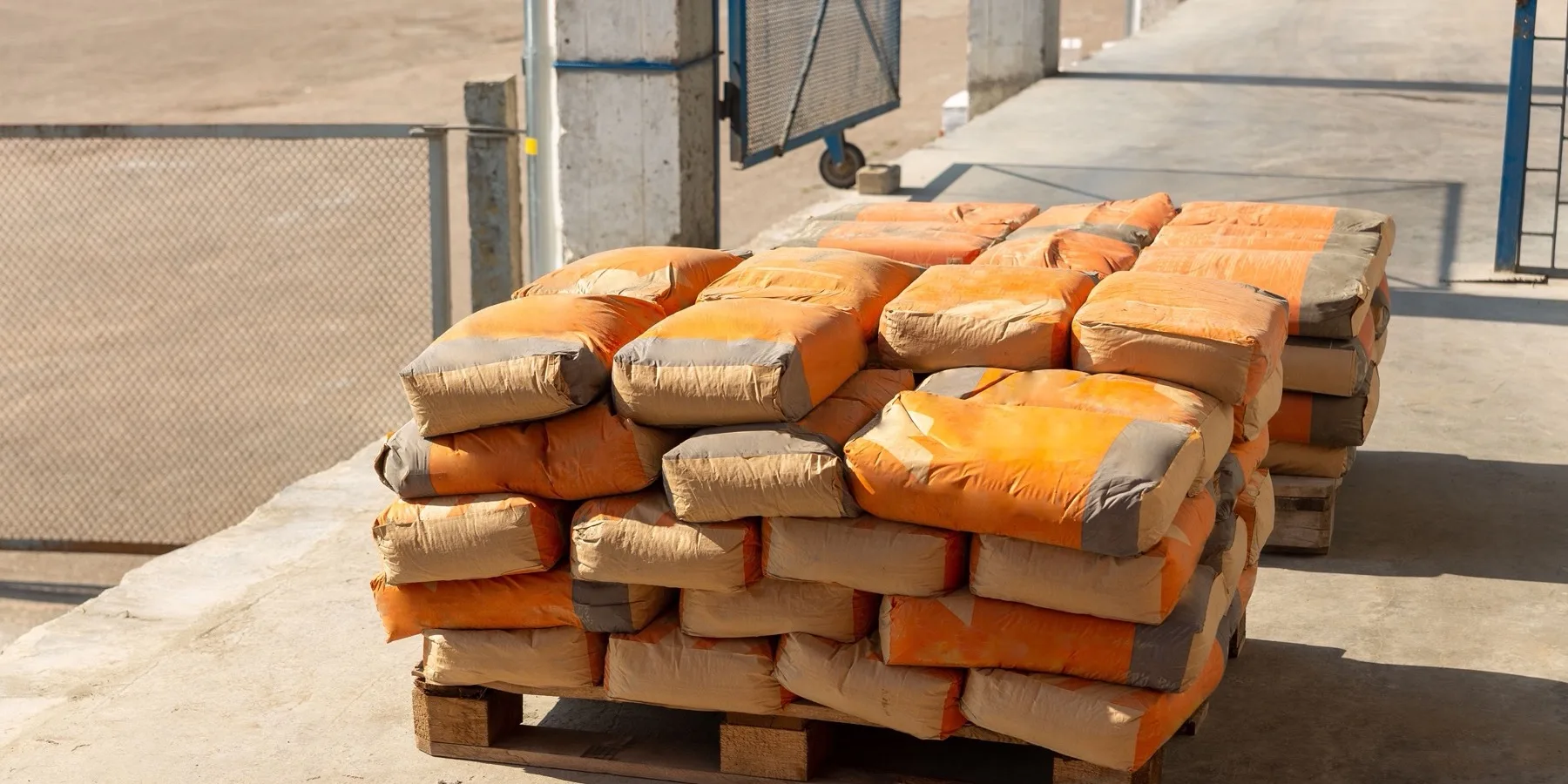 Bags of ready-mix concrete beside a mixer