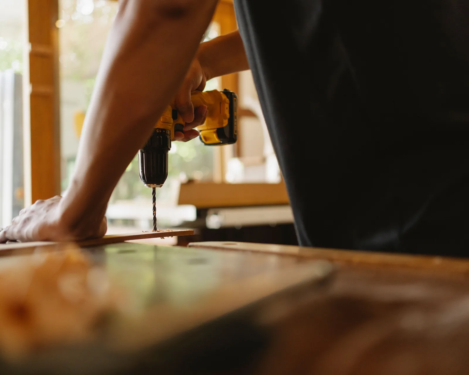 Drilling pilot holes in a board before it is screwed down