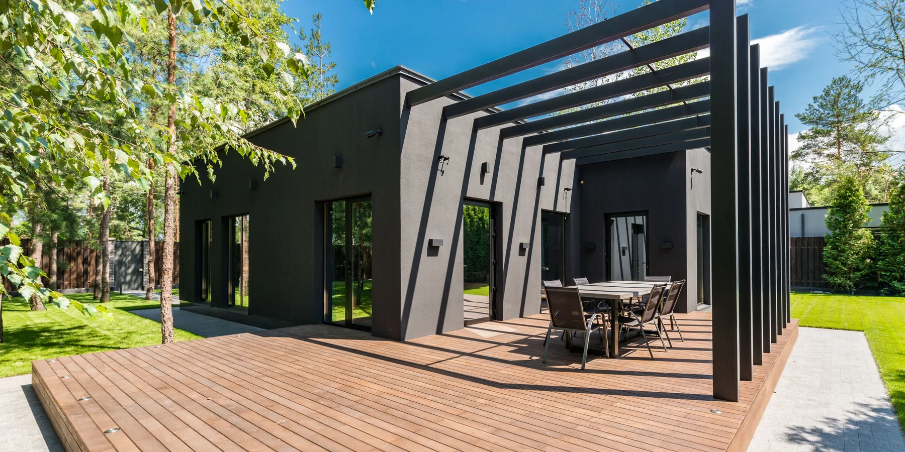A wooden deck built off the back of a house