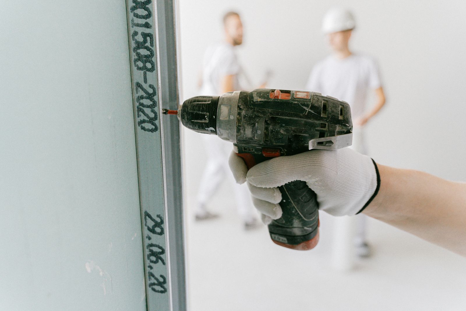 Cordless drill and drywall tools during a ceiling fit-out
