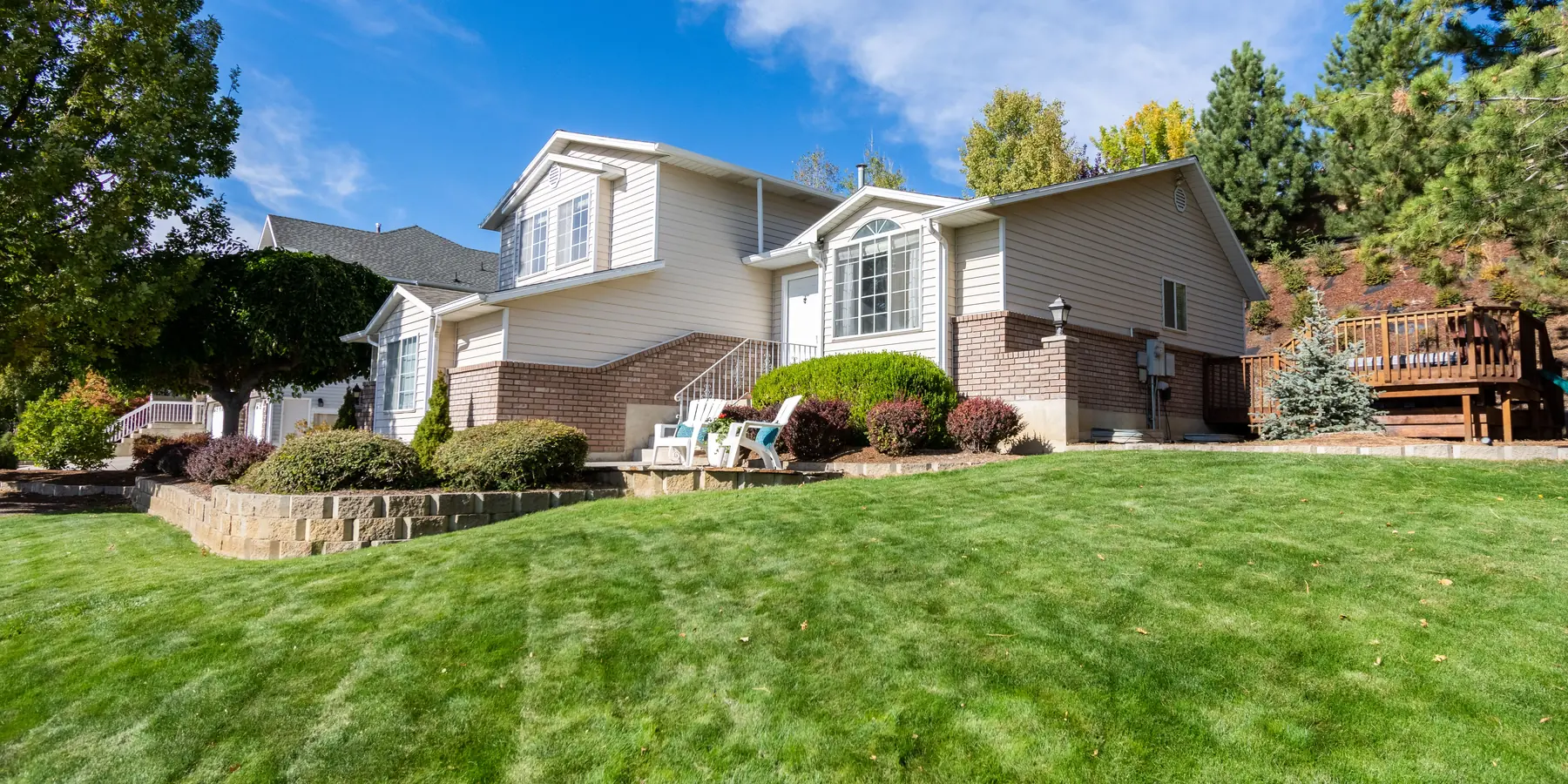 A suburban house behind a thick, well-fed lawn