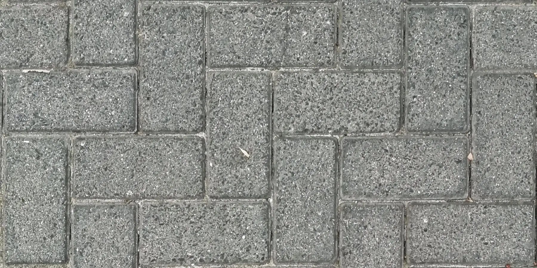 Concrete pavers laid in a herringbone pattern