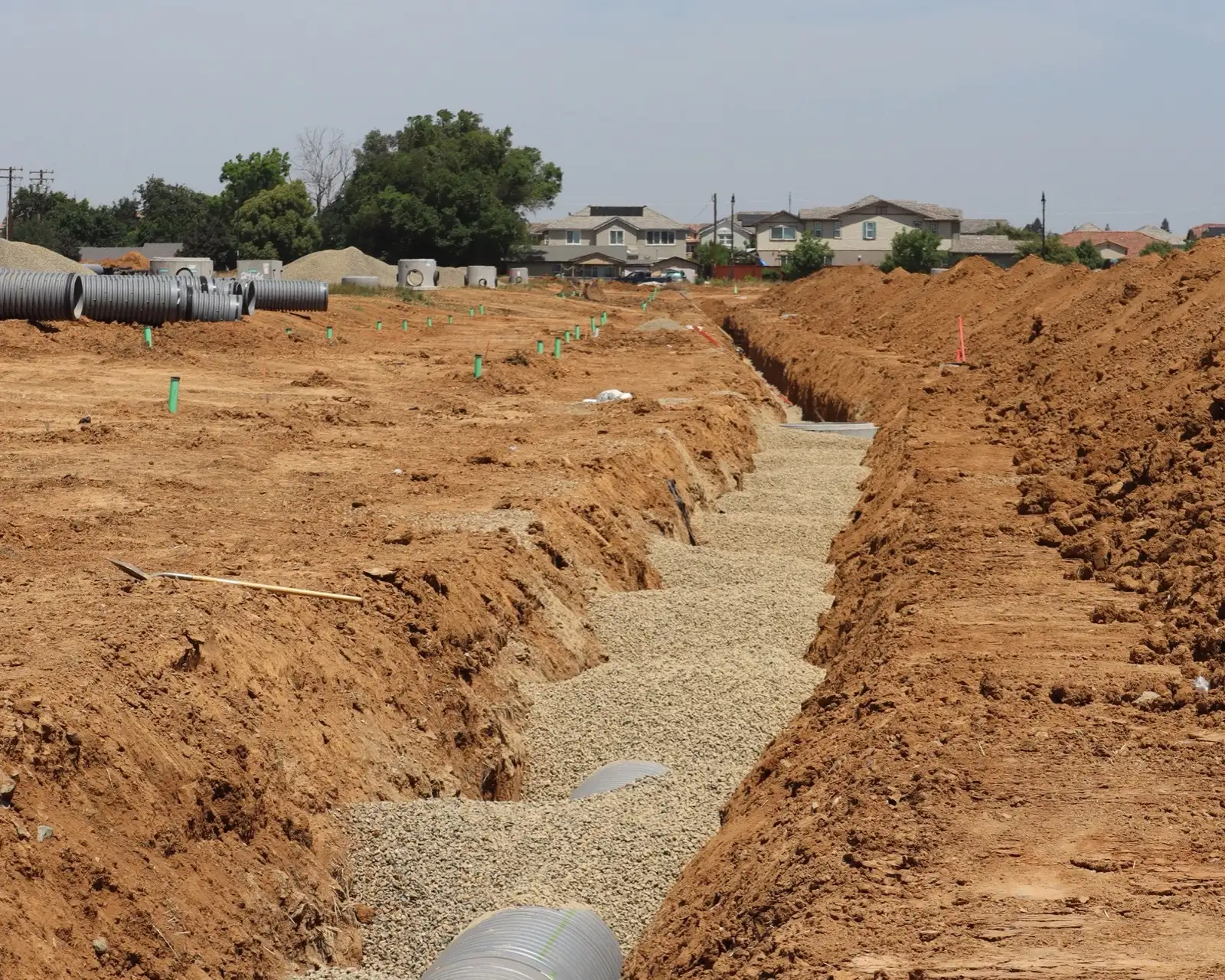 A drainage trench with pipe on a wall site
