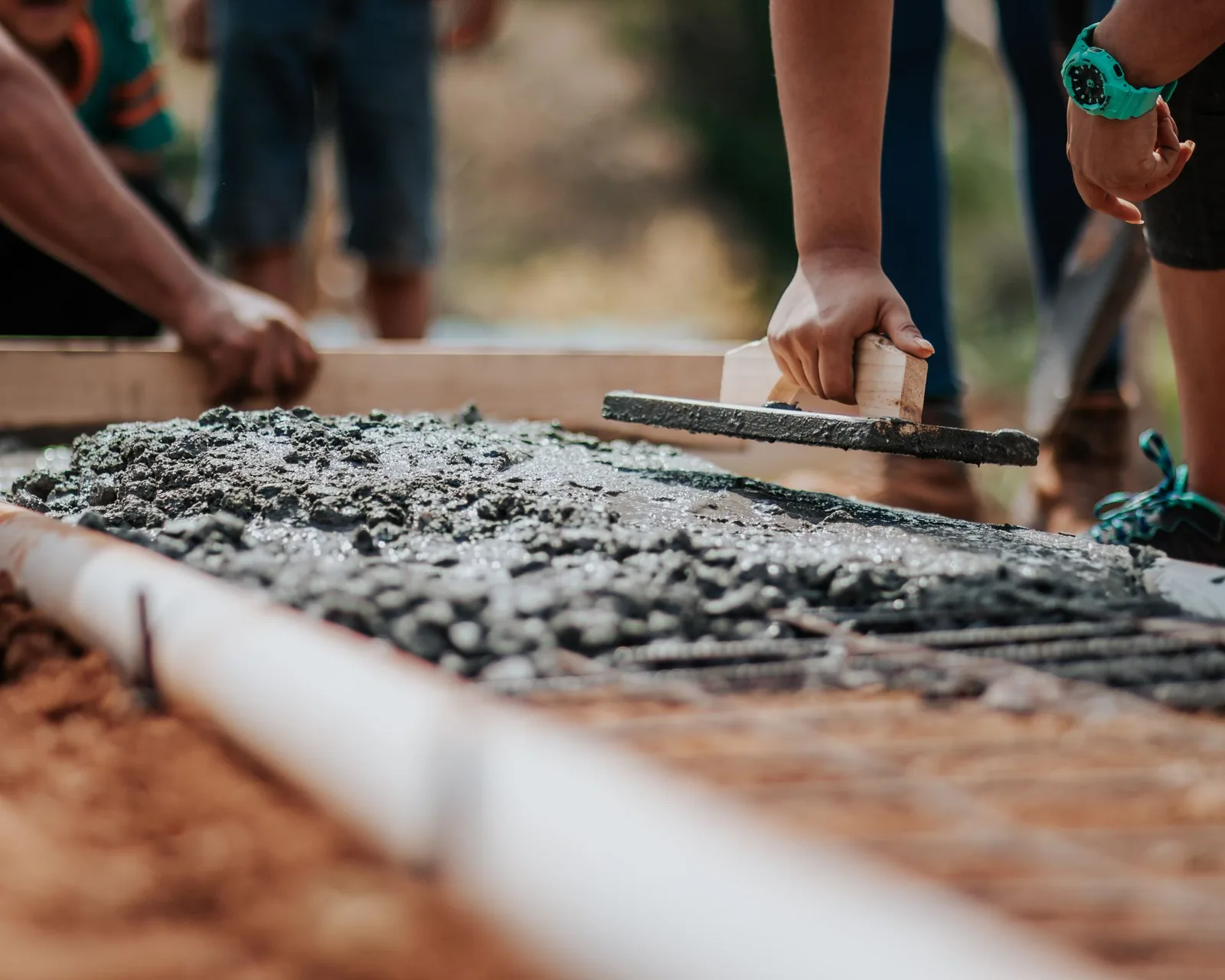 Leveling a fresh screed bed with a straightedge