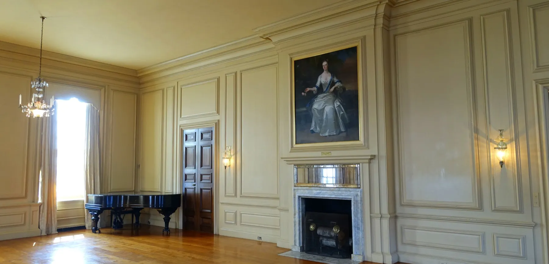 Panelled room with crown molding, wall panel molding and painted baseboard