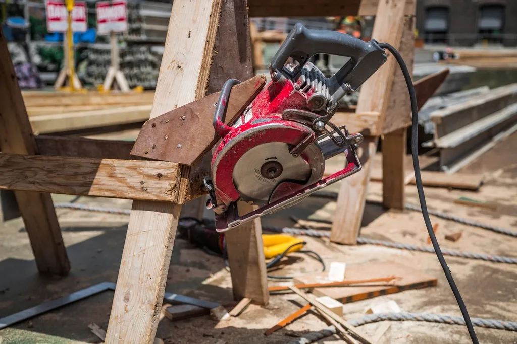 Circular saw resting on timber lengths on a carpentry workbench