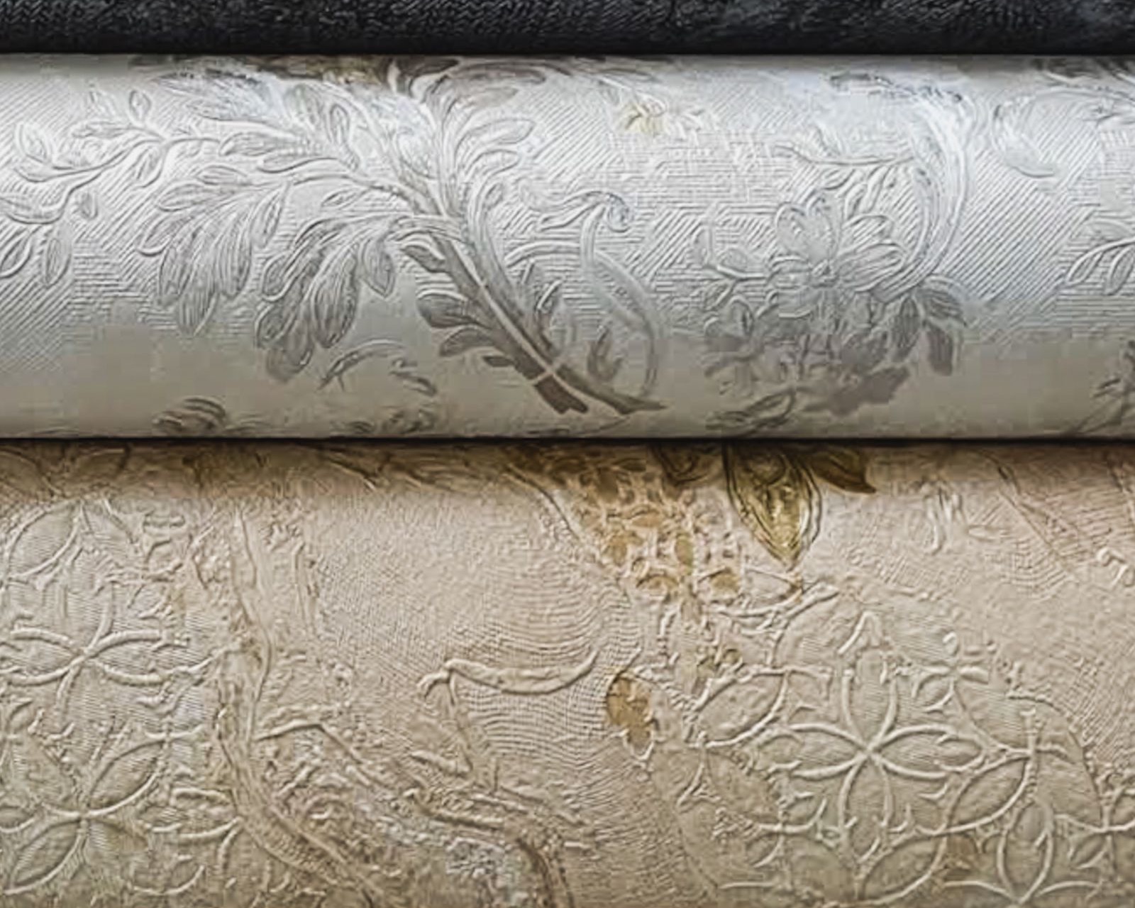 A stack of patterned wallpaper rolls